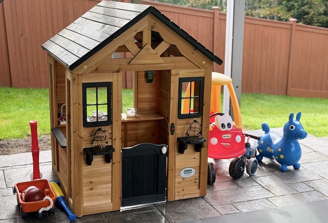 Backyard playhouse and ride-on toys