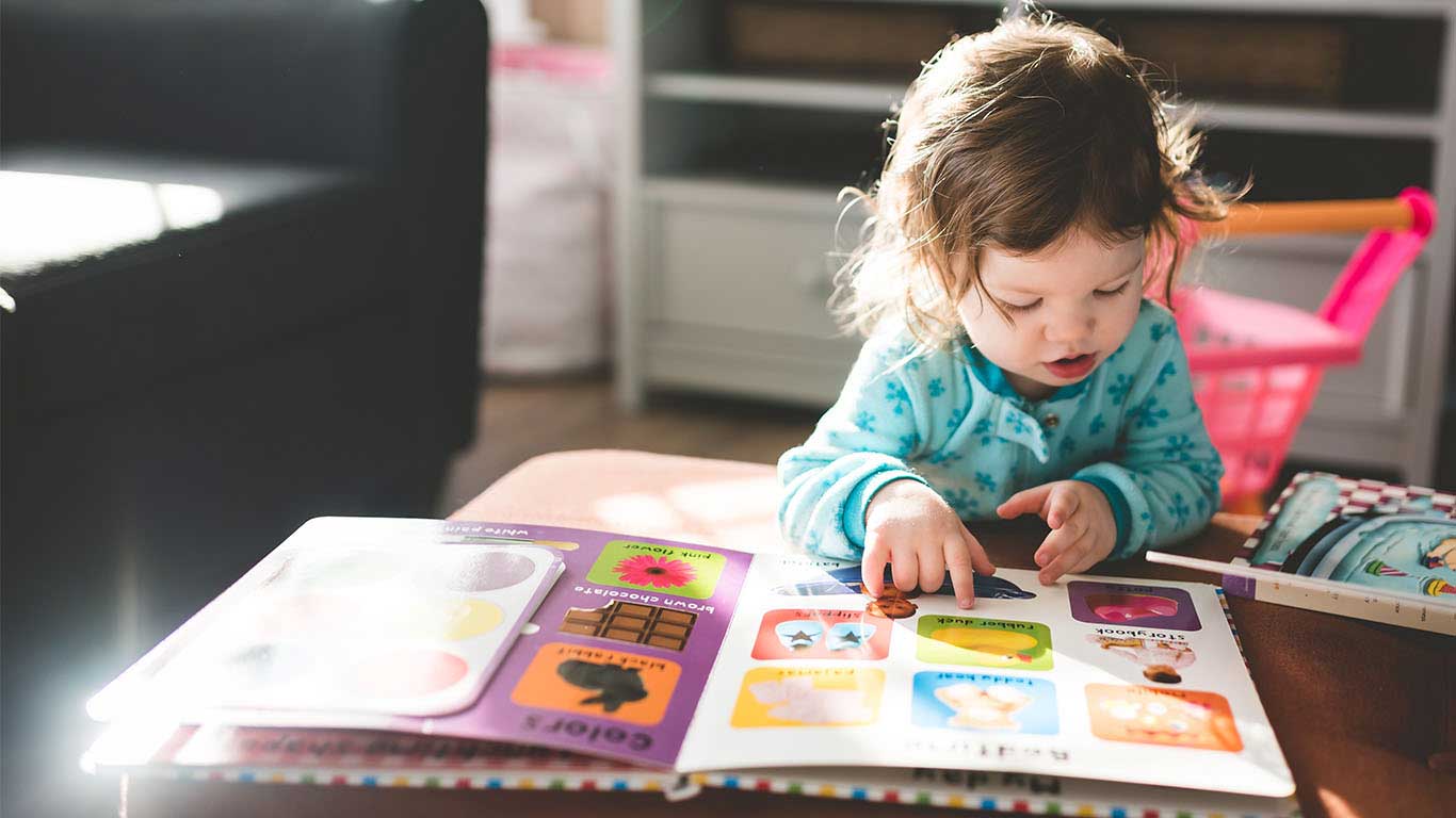 A child playing with learning materials at Blooming Bees